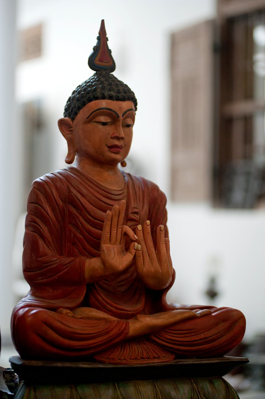 A peaceful wooden Buddha statue symbolizing tranquility and spirituality indoors.